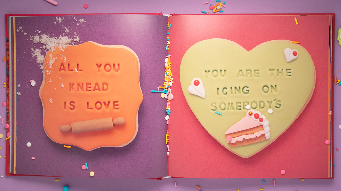 open book with cookies on pages on a purple background